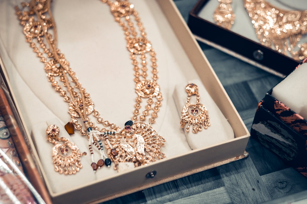 A detailed close-up of an ornate Indian bridal jewelry set in a decorative box, showcasing traditional craftsmanship.