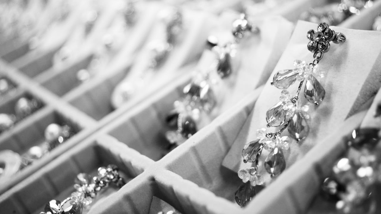 services-04 Close-up of elegant crystal earrings in a display box highlighting intricate jewelry details.